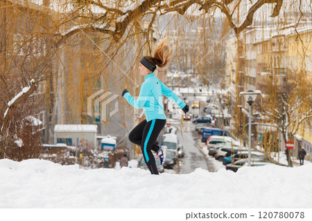 Fit woman running through park. 120780078