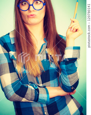 Weird nerdy woman in glasses holding pen 120780141
