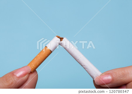 Addiction. Hands breaking cigarette. Quit smoking. 120780347