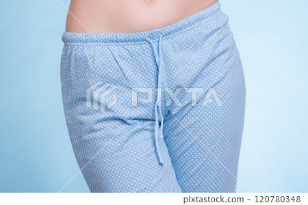 Pyjamas. Female legs wearing blue pajama pants 120780348