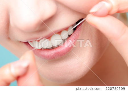 Woman smiling with dental floss. Woman smiling with dental floss. 120780509