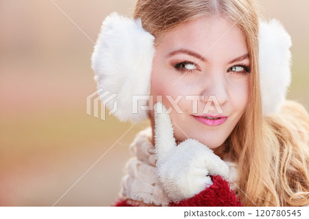 Portrait of suspicious pretty woman in earmuffs 120780545