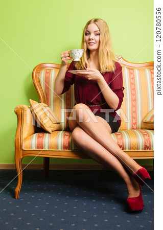 Woman drinking hot coffee beverage. Caffeine. 120780556