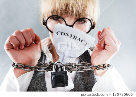 Furious woman with chained hands and contract 120780606