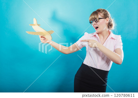 Fly fear. Woman holding airplane in hand. 120780611