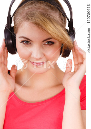 Woman in big headphones listening music isolated 120780618