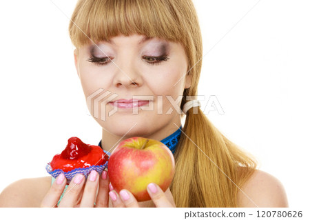 Woman choosing fruit or cake make dietary choice 120780626