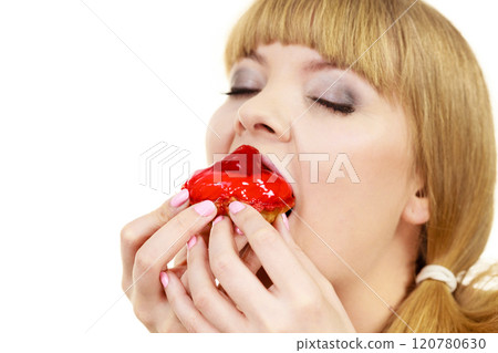 Woman eating cupcake sweet food 120780630