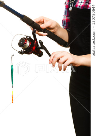 Woman holding fishing rod with float Woman holding fishing rod with float 120780644