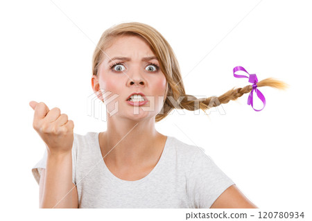 Teenage girl in braid hair making angry face 120780934