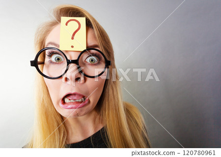 Weirdo nerd woman having question mark on forehead 120780961
