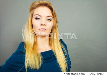 Portrait blonde young woman having serious face expression Portrait blonde young woman having serious face expression 120780968