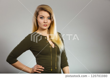 Attractive blonde woman wearing tight green khaki top 120781080