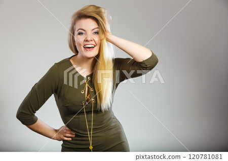 Attractive blonde woman wearing tight green khaki dress Attractive blonde woman wearing tight green khaki dress 120781081