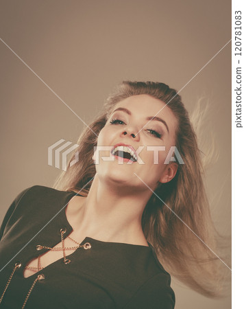 Attractive blonde woman wearing tight green khaki top 120781083