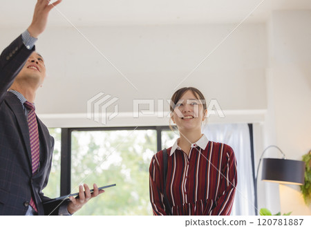A woman and a salesman looking at a property A woman and a salesman looking at a property 120781887