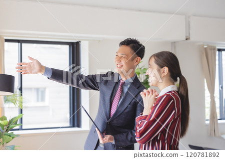 A woman and a salesman looking at a property A woman and a salesman looking at a property 120781892