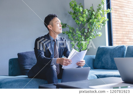 Businessmen having a meeting while looking at documents 120781923