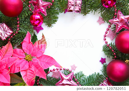Festive Christmas arrangement featuring pink poinsettia, fir branches, pink and fuchsia ornaments, glittering stars and beads with empty white space in the center for text for holiday themed projects Festive Christmas arrangement featuring pink poinsettia, fir branches, pink and fuchsia ornaments, glittering stars and beads with empty white space in the center for text for holiday themed projects 120782051