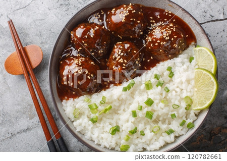Honey Sriracha Glazed Meatball served with rice closeup on the bowl. Horizontal top view Honey Sriracha Glazed Meatball served with rice closeup on the bowl. Horizontal top view 120782661