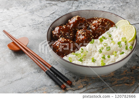 Spicy sweet chinese meatballs in honey sriracha sauce served with rice close-up in bowl. horizontal Spicy sweet chinese meatballs in honey sriracha sauce served with rice close-up in bowl. horizontal 120782666