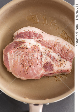 Cook pork shoulder steak in a frying pan Cook pork shoulder steak in a frying pan 120782711