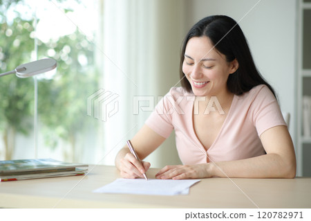 Happy asian woman signing contrat in a room 120782971