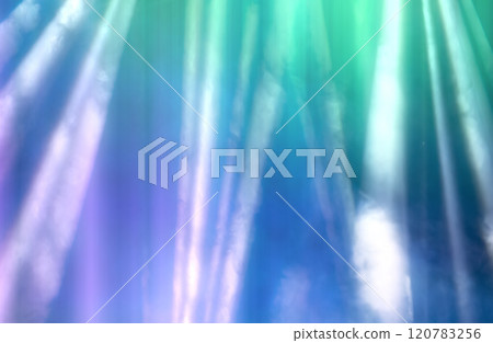 Blurred rays of light from stage spotlights on a purple-green background. 120783256