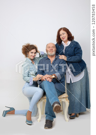 Family portrait of an adult daughter and elderly parents on a gray background. 120783458