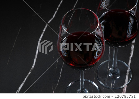 Image of two wine glasses filled with red wine making a toast Image of two wine glasses filled with red wine making a toast 120783751
