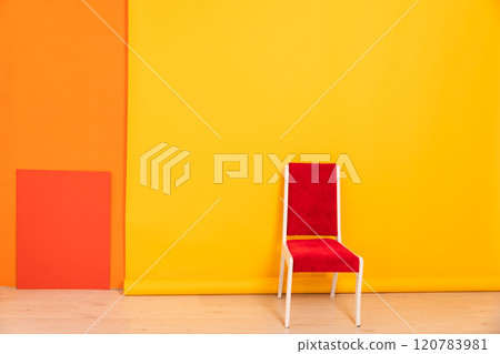 One vintage chair in the interior of a yellow orange living room One vintage chair in the interior of a yellow orange living room 120783981