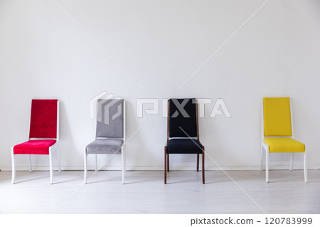 Four colorful vintage chair in the interior of an empty room 120783999