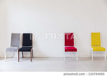 Four colorful vintage chair in the interior of an empty room Four colorful vintage chair in the interior of an empty room 120784000