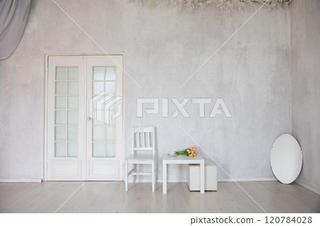 mirror, table and chair in the interior of an empty white room mirror, table and chair in the interior of an empty white room 120784028