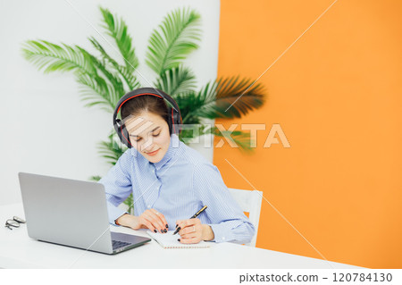 Business woman in headphones learning online Business woman in headphones learning online 120784130