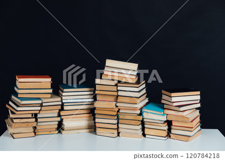 Stacks of books for reading and education in college library on black background 120784218