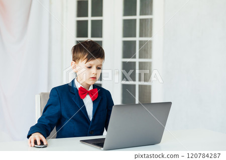 boy in business suit studying playing on laptop online 120784287