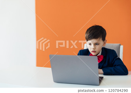 Boy In Business Suit Studying Playing On Laptop Online Boy In Business Suit Studying Playing On Laptop Online 120784290