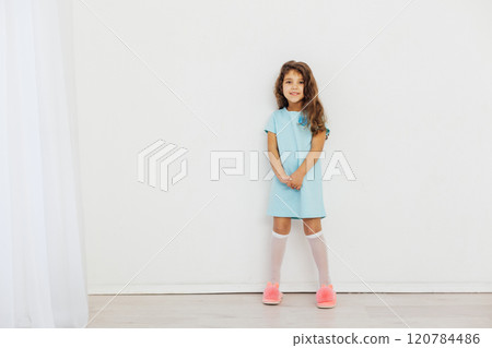 Little Curly Girl in Blue Dress on White Background 120784486