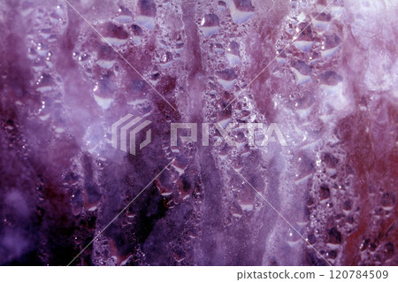 Deilcate Rain Drops of Water on Glass in a Red Pink Glow for Background 120784509