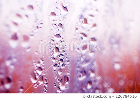 Deilcate Rain Drops of Water on Glass in a Red Pink Glow for Background 120784510