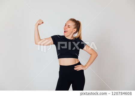 Beautiful athletic woman showing her biceps Beautiful athletic woman showing her biceps 120784608