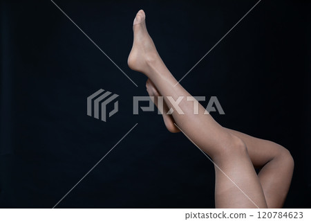 female legs in tights stockings on a black background 120784623