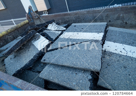 Broken pavement is collected by truck Broken pavement is collected by truck 120784664
