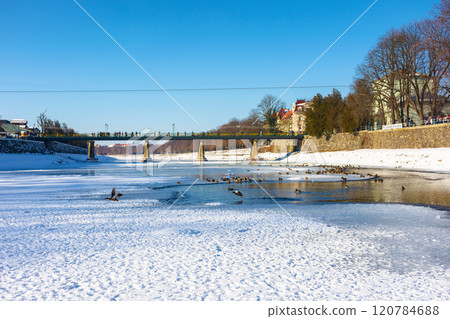 uzhhorod, ukraine - 19 jan, 2017: bridge on the river uz in winter. sunny weather. urban landscape of the old city downtown uzhhorod, ukraine - 19 jan, 2017: bridge on the river uz in winter. sunny weather. urban landscape of the old city downtown 120784688