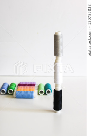 Many colorful sewing threads on light background. 120785838