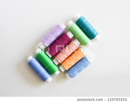 Many colorful sewing threads on light background. 120785858