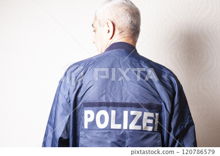Man in a nylon jacket with the inscription in German POLICE 120786579