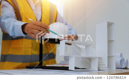 Construction and structure concept of Engineer or architect meeting for project working with partner and engineering tools on model building and blueprint in working site, contract for both companies. 120786814