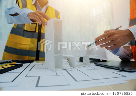 Construction and structure concept of Engineer or architect meeting for project working with partner and engineering tools on model building and blueprint in working site, contract for both companies. 120786825